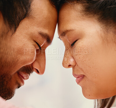 Buy stock photo Closeup of mixed race man loving his asian wife. Headshot of hispanic couple bonding and sharing an intimate moment at home. Beautiful woman with freckles feeling in love with boyfriend