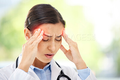 Buy stock photo A young mixed race female doctor sitting alone in her clinic and feeling stressed. Hispanic woman suffering a migraine while in a office at work in a hospital