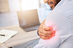 Closeup of shoulder pain highlighted in red. A businessman holding his arm with an injury. Male employee working at his desk in a modern office and suffering from a medical problem