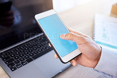 Closeup hand of businessman using smartphone. Businessman scrolling online on cellphone. Businessman working on laptop in his office. Zoom on hand of businessman using internet apps