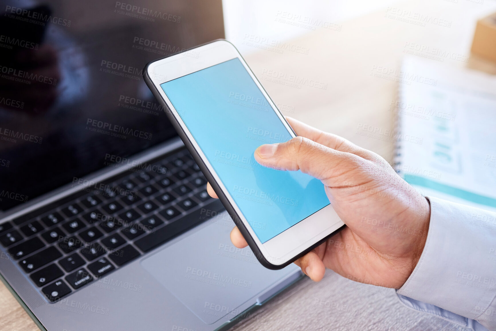 Buy stock photo Closeup hand of businessman using smartphone. Businessman scrolling online on cellphone. Businessman working on laptop in his office. Zoom on hand of businessman using internet apps