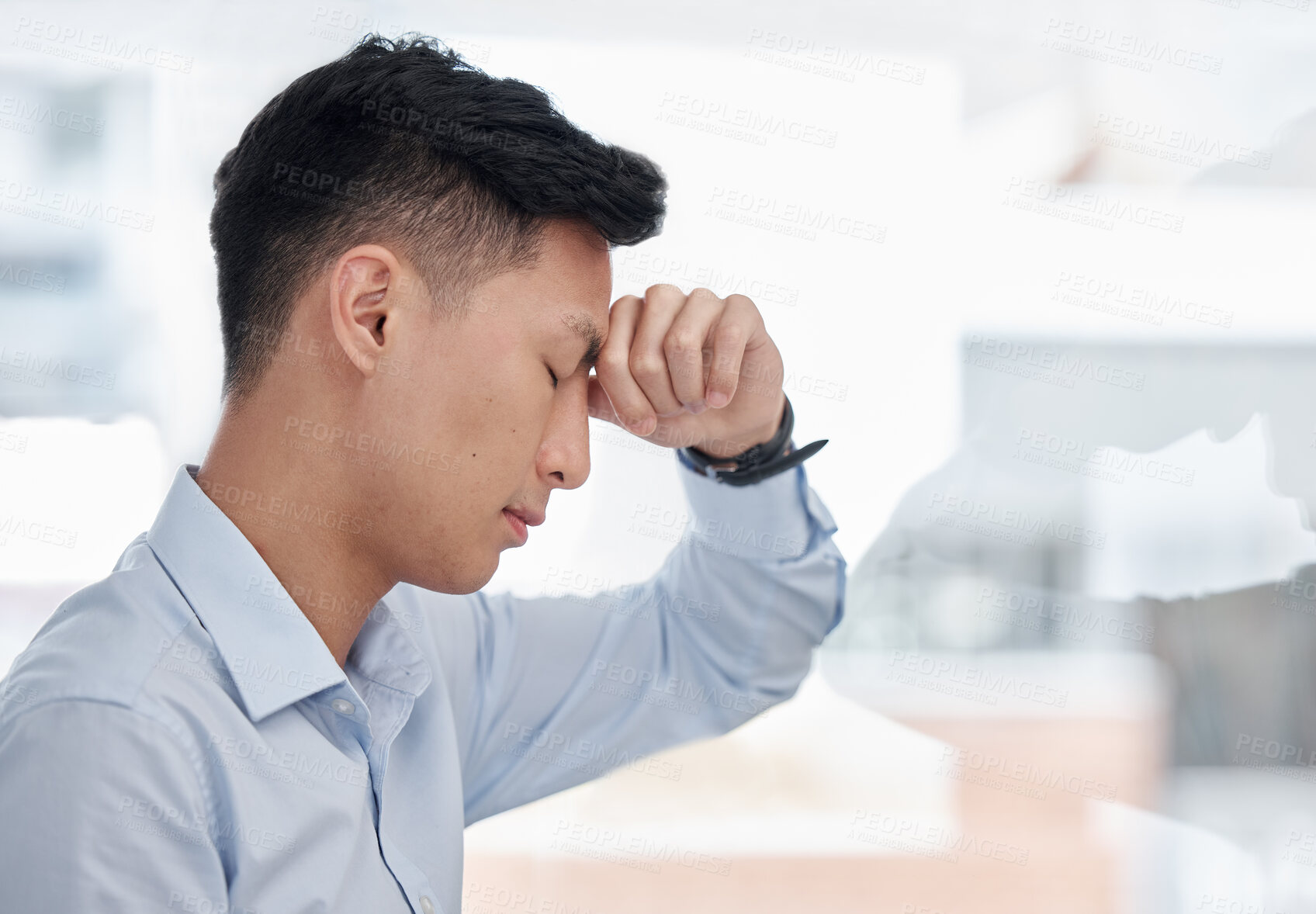 Buy stock photo Closeup of asian business man looking stressed at office. Overworked professional looking tired exhausted struggling to reach deadline due to headache. Man feeling disappointed after failure