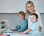 Portrait of a young happy caucasian mother helping her sons with homework at home. Carefree siblings smiling having fun and drawing with their mom. Brothers doing schoolwork with the help of mom
