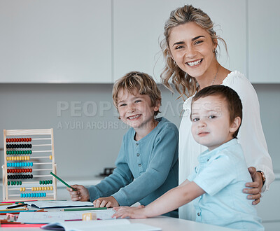 Portrait of a young happy caucasian mother helping her sons with homework at home. Carefree siblings smiling having fun and drawing with their mom. Brothers doing schoolwork with the help of mom