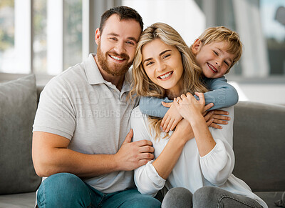 Buy stock photo Happy caucasian family of three looking relaxed while sitting and bonding on the sofa together. Adorable little blonde boy chilling on a couch with his loving parents while hugging them 