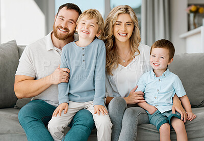 Buy stock photo Portrait of a happy caucasian family looking relaxed while bonding on a sofa together. Adorable little boys chilling on a couch with their loving parents while smiling and looking positive