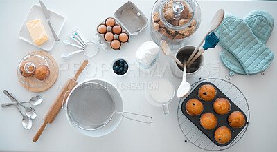 Various baking products on kitchen counter from above. Baking utensils on a kitchen table. Still life of food and cooking ingredients on a table. Assorted baking supplies flatlay on a kitchen counter