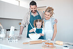 Happy parents watching their daughter bake. Little girl mixing a bowl of batter.Happy child cooking with her parents. Caucasian family baking together in the kitchen. Family enjoying cooking together