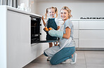 Smiling mother and daughter baking together. Happy parent and child holding tray of baked muffins.Caucasian woman taking fresh, baked muffins out of the oven. Portrait of a mother and daughter baking
