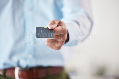 Buy stock photo Businessman holding a credit card. Closeup of hand of businessman holding a debit card. Zoom into hand of businessman using card to make online payments. Card used for online, ecommerce shopping
