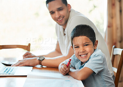 Buy stock photo Excited preschooler boy drawing and writing with crayon at table at home while dad works remotely. Child sitting with parent during online education classes