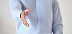 Unknown businessman extending his hand for a handshake in the office. Mixed race professional getting ready to seal a deal with a hand gesture. Hispanic entrepreneur greeting and offering a promotion