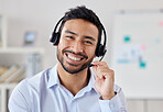 Portrait Face of happy mixed race call centre telemarketing agent with big smile talking on headset while working in office. Confident friendly businessman operating helpdesk for customer service sales support
