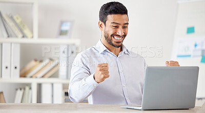 Young happy and excited mixed race businessman cheering in support while working on a laptop alone in an office at work. One hispanic male boss smiling while celebrating success and victory