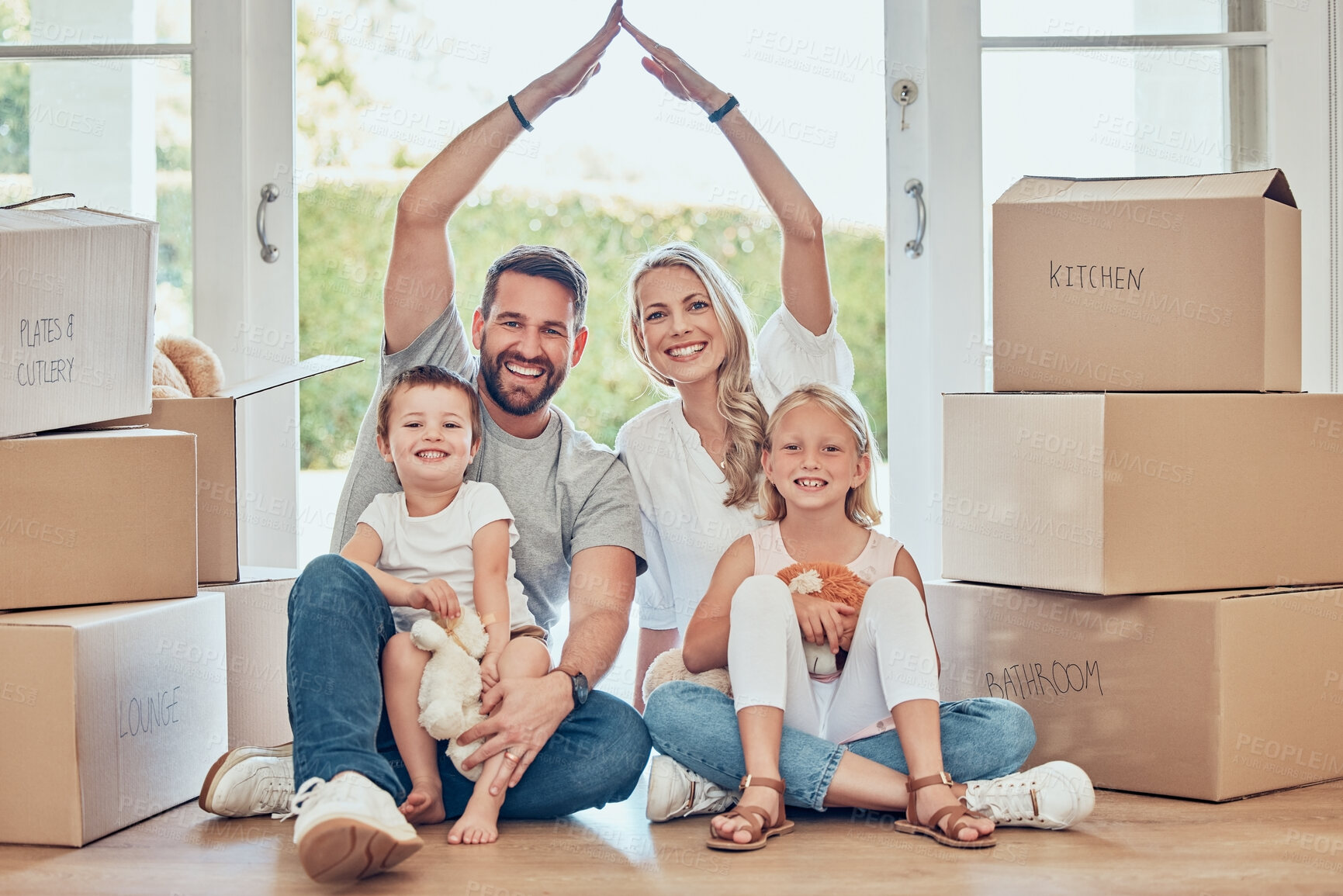 Buy stock photo Portrait of happy family, new house and roof hands for insurance, safety and future investment in real estate. Moving, boxes and happiness, woman and man with kids in home with property mortgage.