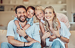 Portrait of happy family at home. Caucasian family at home. Mother and father bonding with their children. Brother and sister relaxing at home with their parents. Siblings hugging their parents