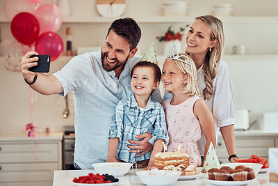 Buy stock photo Happy family celebrating a birthday at home. Parents smiling for selfie or video call with kids while having a party with balloons and cake. Sister celebrating birthday with mother, father and brother