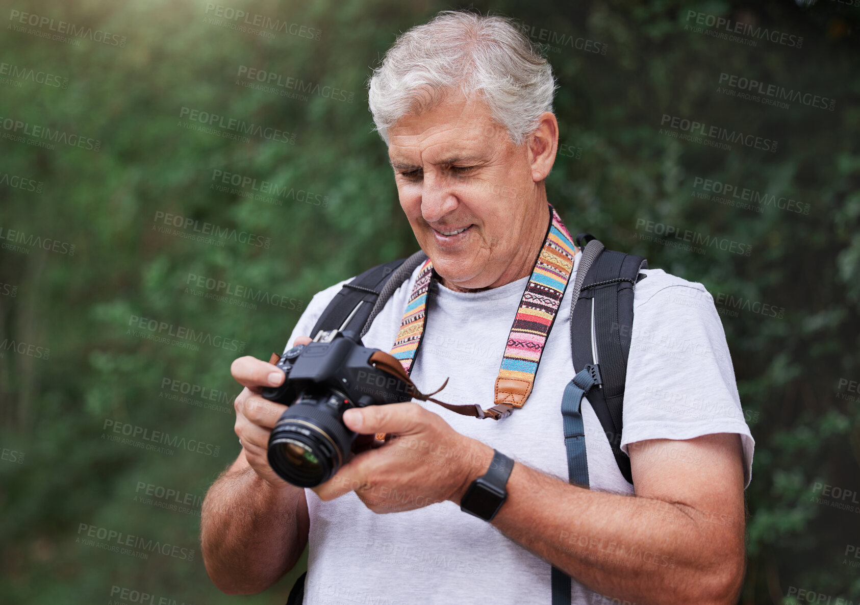 Buy stock photo Senior man, hiking and photography with camera in forest, nature and green environment. Happy male hiker, tourist and travel photographer on trekking adventure, sightseeing journey or explore scenery