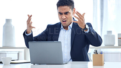 Angry mixed race businessman getting mad and annoyed with bad news and mistakes on broken laptop in an office. Hispanic guy expressing rage and stress while having problems with slow internet connection, software failure error and data loss