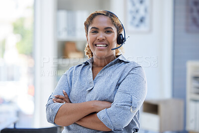 Portrait of one happy smiling african american call centre telemarketing agent standing with arms crossed while talking on headset in office. Confident and friendly businesswoman operating helpdesk for customer service and sales support