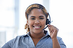 Portrait of one happy smiling african american call centre telemarketing agent talking on headset in office. Face of confident and friendly businesswoman operating helpdesk for customer service and sales support