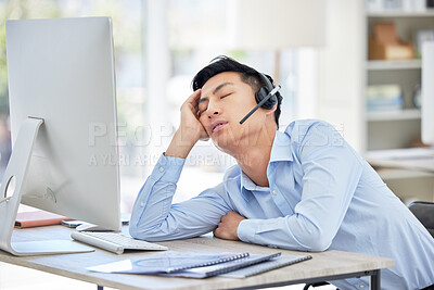 Buy stock photo Man, call center and headset or sleep at desk for burnout fatigue, tired stress or talking customer fail. Asian person, nap at telemarketing work for headache exhausted, employee relax or overtime