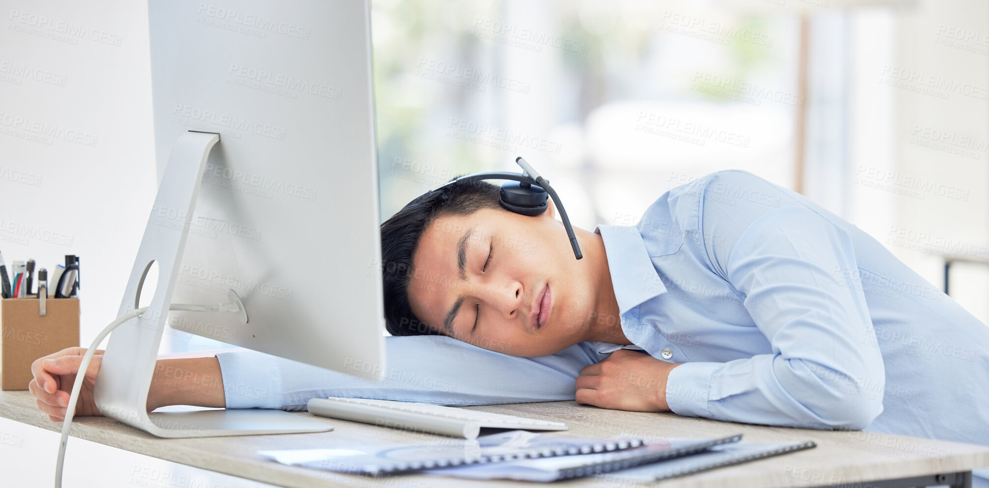 Buy stock photo Call center, businessman and sleeping on desk and tired while being overworked and exhausted. Nap, rest and contact us overtime with a male person or agent sleep in customer service job 