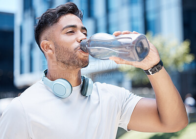 Buy stock photo Man, fitness and drinking water in city exercise, cardio workout or running for sustainability outdoors. Thirsty male person, athlete or runner with drink for hydration, rest or break in urban town
