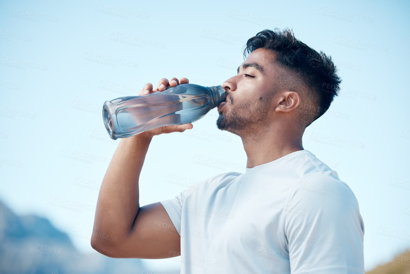 Buy stock photo Man, fitness and drinking water in nature exercise, cardio workout or running for sustainability outdoors. Thirsty male person, athlete or runner with drink for hydration, rest or break on mountain