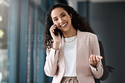 Businesswoman talking on her cellphone. Entrepreneur making a call on her smartphone. Portrait of smiling businesswoman on a phone call. Businesswoman in her office making a call on her mobile