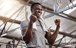 Smiling african american athlete making fist to celebrate success during workout in gym. Strong, fit, active black man feeling excited and cheering after training exercise in health and sports club