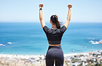 Rear view of a unknown fit and active woman celebrating a successful workout in the outdoors