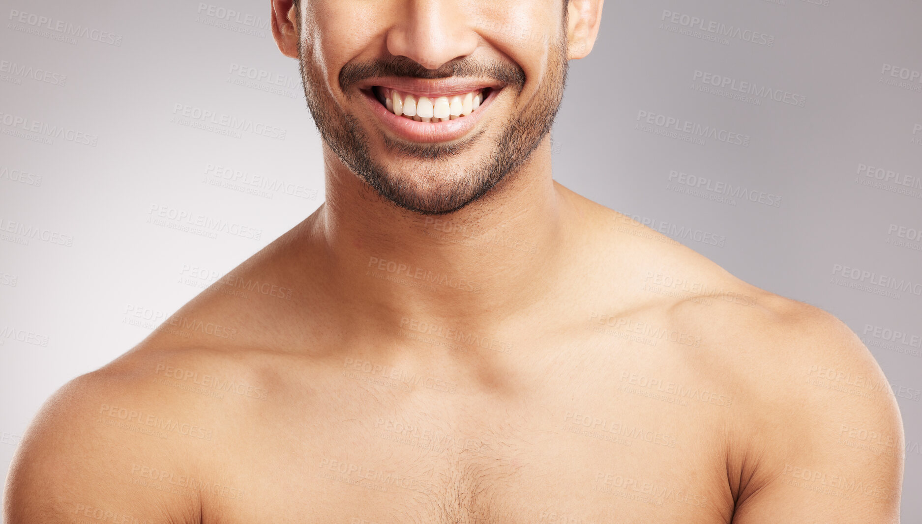 Buy stock photo Closeup young mixed race man shirtless in studio isolated against a grey background. Hispanic well groomed male looking confident and happy with his oral and dental hygiene. Mouth and gum health