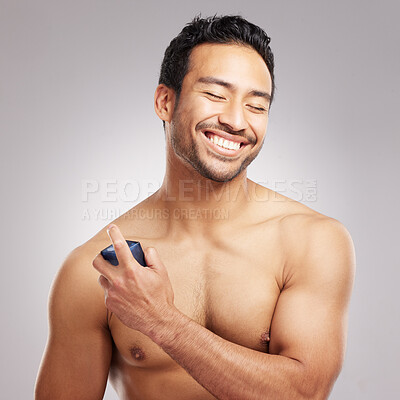 Buy stock photo Perfume, man or happy with spray in studio for odor protection, fresh fragrance or grooming routine. Space, topless person or smile with cologne on gray background for hygiene, cosmetics or self care