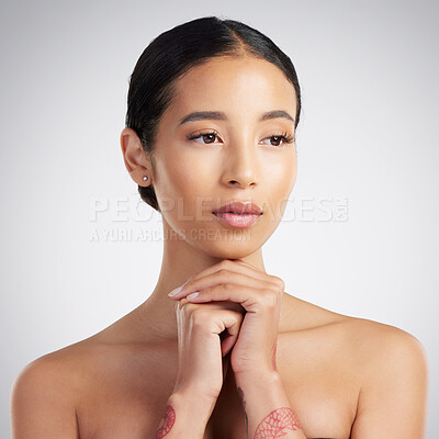 Buy stock photo A beautiful young mixed race woman with glowing skin posing against grey copyspace background. Hispanic woman with natural looking eyelash extensions is a confident natural beauty in a studio