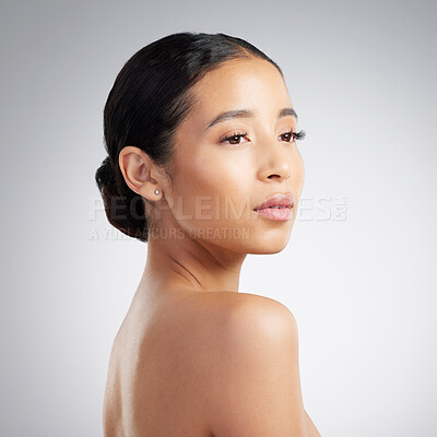 Buy stock photo A beautiful young mixed race woman with glowing skin posing against grey copyspace background. Hispanic woman with natural looking eyelash extensions is a confident natural beauty