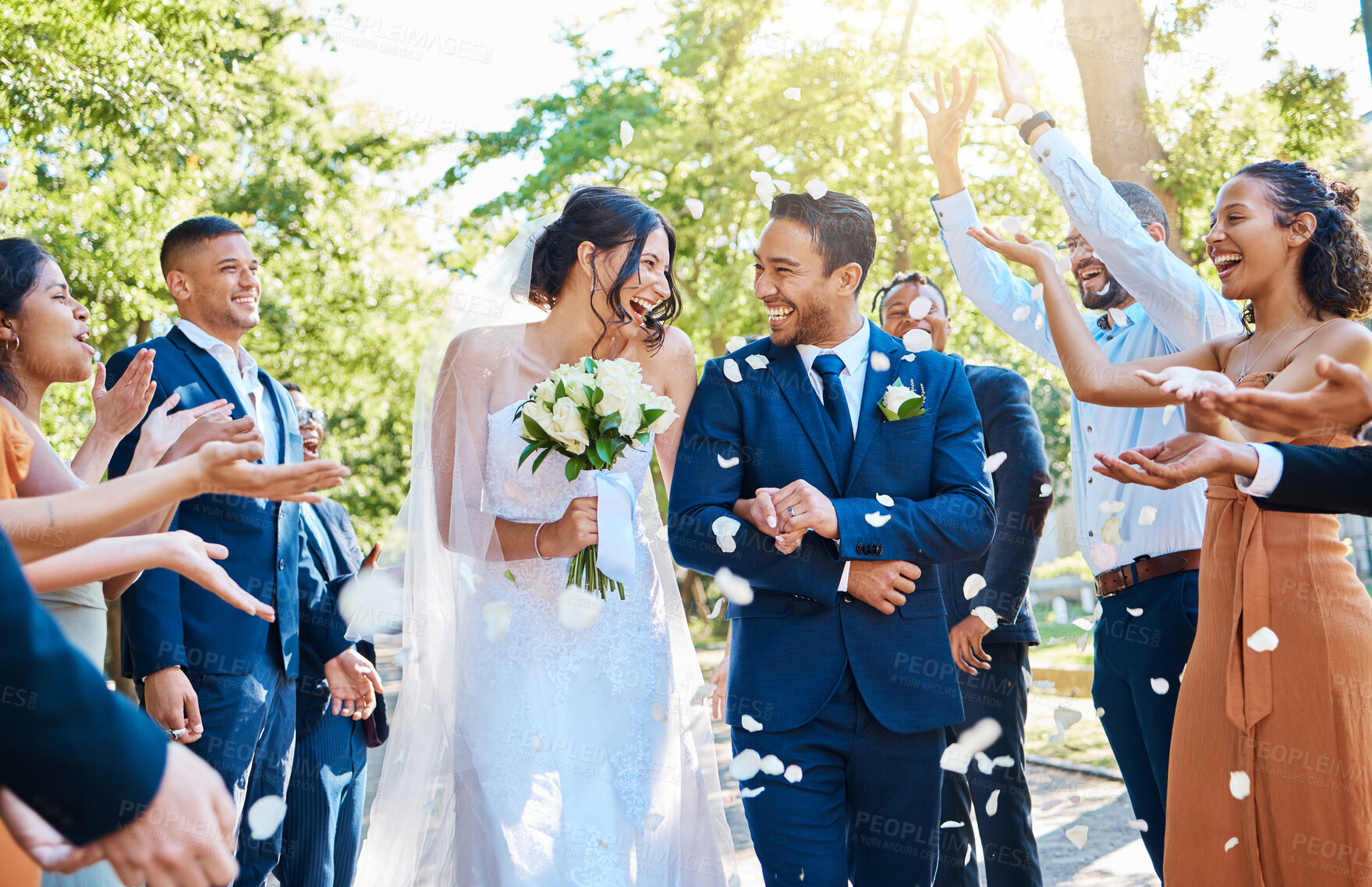 Buy stock photo Happy, wedding ceremony and couple walking with petals and guests throw in celebration of romance. Romantic, flowers and bride with bouquet and groom with crowd celebrating at outdoor marriage event.
