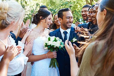 Buy stock photo Happy bride and groom standing together while greeting guests after their wedding ceremony. Newlyweds smiling while friends and family congratulate them on their marriage