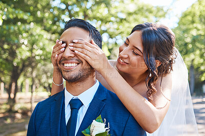 Buy stock photo Playful bride covering grooms eyes from behind and surprising him. Happy couple on their wedding day. Taking first look at bride
