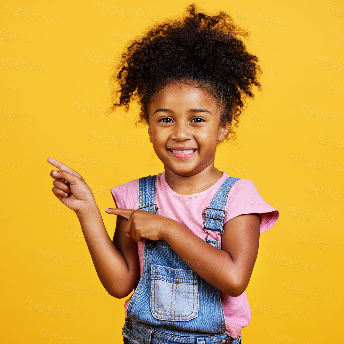 Buy stock photo Portrait, studio and happy child pointing hand at space with a smile on face on yellow background. Young girl kid with happiness, carefree and positive attitude to show product placement mockup deal