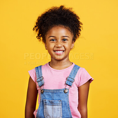 Buy stock photo Studio portrait mixed race girl looking standing alone isolated against a yellow background. Cute hispanic child posing inside. Happy and cute kid smiling and looking carefree in casual clothes