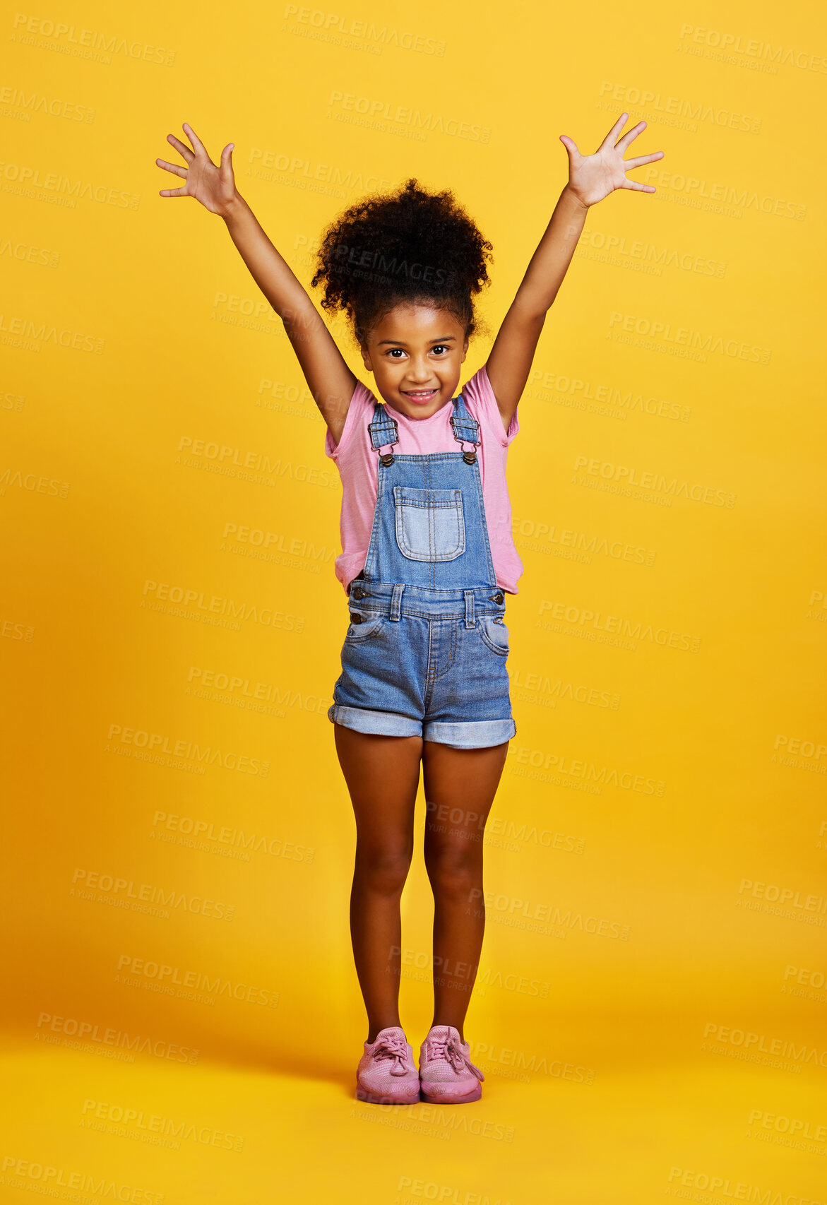 Buy stock photo Studio, portrait and excited child with hands up and a smile on face on yellow background. Happy young girl kid model with happiness, carefree and positive attitude for surprise sale announcement