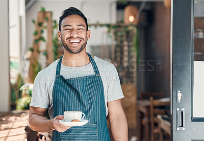 Portrait of one young hispanic waiter serving a cup of coffee while working in a cafe. Friendly barista and coffeeshop owner managing a successful restaurant startup