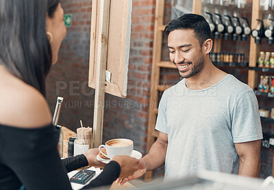 Buy stock photo Young hispanic waiter serving a cup of coffee to a customer while working in a cafe. Friendly barista and coffeeshop owner managing a successful restaurant startup