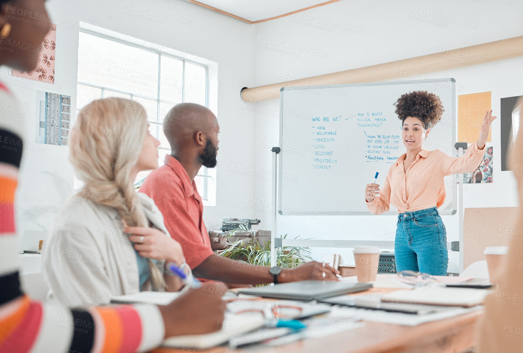 Buy stock photo Group of diverse businesspeople having a meeting in a modern office at work. Young hispanic businesswoman talking while doing a presentation of an idea on a whiteboard in a boardroom with colleagues. Businesspeople planning together