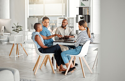 Buy stock photo Group of diverse businesspeople having a meeting in an office at work. Young african american businesswoman talking to her colleagues while sitting at a table. Businesspeople planning together