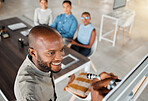Group of diverse businesspeople having a meeting in an office at work. Young happy african american businessman smiling while writing an idea on a whiteboard in a boardroom with colleagues. Businesspeople planning together