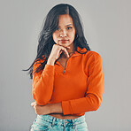 Portrait of mixed race woman isolated against grey studio background with copyspace and feeling flirty. Young, sultry, seductive hispanic standing alone. One model posing with confidence and attitude