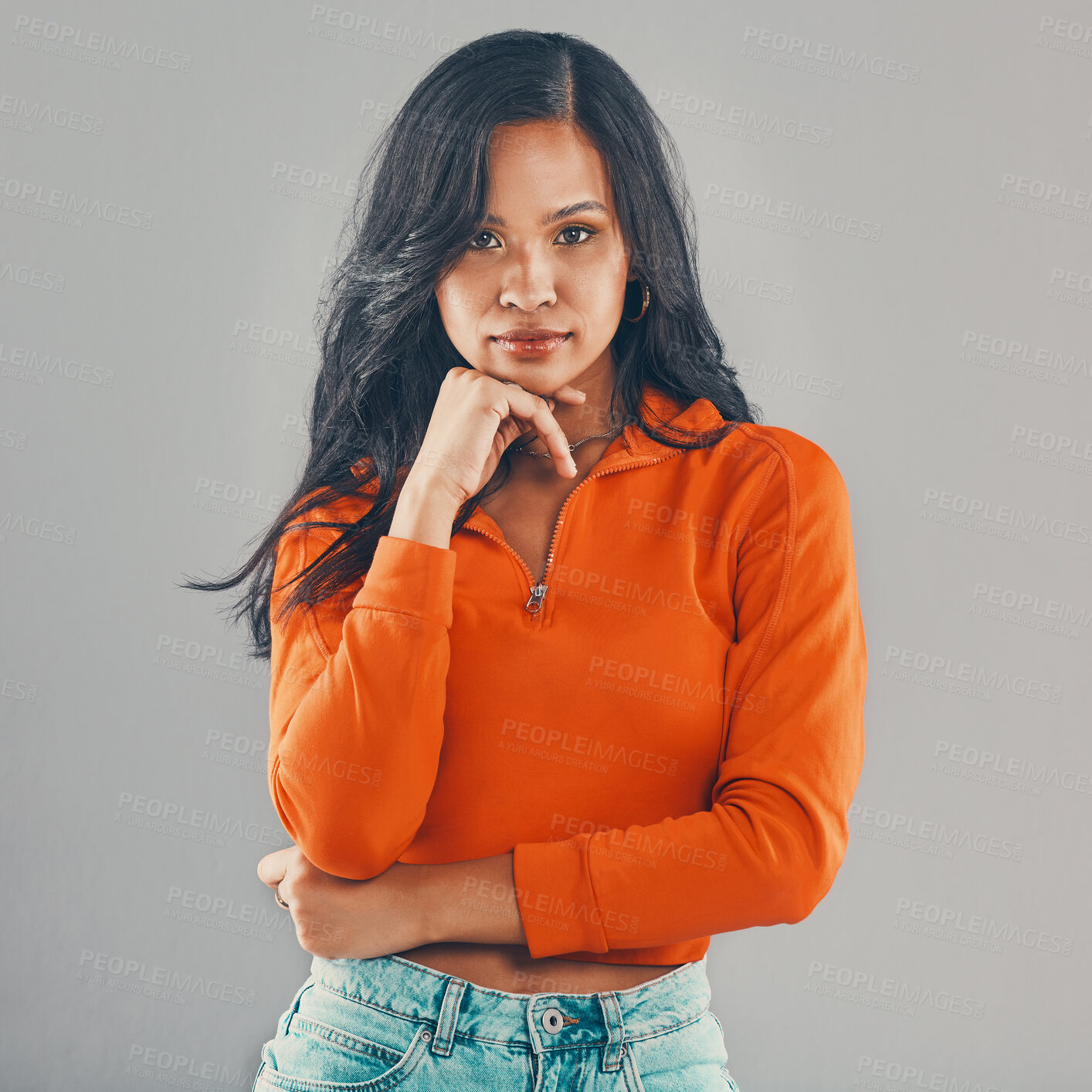 Buy stock photo Portrait of mixed race woman isolated against grey studio background with copyspace and feeling flirty. Young, sultry, seductive hispanic standing alone. One model posing with confidence and attitude