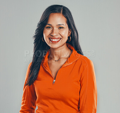 Buy stock photo Portrait of smiling mixed race woman isolated against grey studio background with copyspace. Beautiful young hispanic standing alone and feeling happy. One brunette model feeling confident and posing